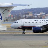 A US Airways plane (R) taxis for takeoff past an American Airlines plane at the Ronald Reagan Washington National Airport in Arlington Count A US Airways plane (R) taxis for takeoff past an American Airlines plane at the Ronald Reagan Washington National Airport in Arlington Count