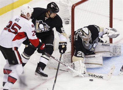 Pittsburgh Penguins goalie Marc-Andre Fleury (29) blocks a shot by Otttawa Senators' Chris Neil (25) as Penguins' Deryk Engelland (5) tries Pittsburgh Penguins goalie Marc-Andre Fleury (29) blocks a shot by Otttawa Senators' Chris Neil (25) as Penguins' Deryk Engelland (5) tries