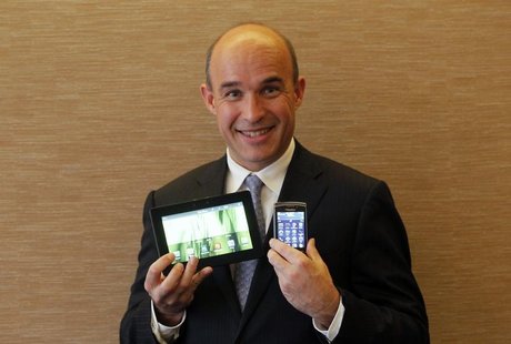 Research In Motion (RIM) Co-Chief Executive Jim Balsillie smiles as he poses with a PlayBook tablet computer (L) and a Blackberry Torch duri Research In Motion (RIM) Co-Chief Executive Jim Balsillie smiles as he poses with a PlayBook tablet computer (L) and a Blackberry Torch duri