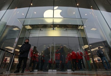 Security guards and staff stand at the entrance of an Apple store during the release of iPhone 5 in Beijing's Wangfujing shopping district, Security guards and staff stand at the entrance of an Apple store during the release of iPhone 5 in Beijing's Wangfujing shopping district,