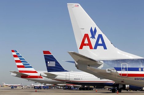 The tail sections of a newly designed American Airlines aircraft (L), a US Airways aircraft (C) and a traditional American Airlines aircraft The tail sections of a newly designed American Airlines aircraft (L), a US Airways aircraft (C) and a traditional American Airlines aircraft