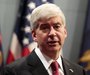 Michigan Governor Rick Snyder holds a news conference to talk about why he signed into law right-to-work laws in Lansing, Michigan December 