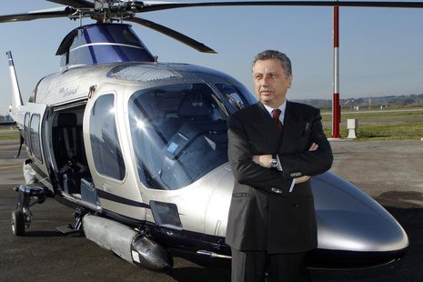 Finmeccanica Chairman and Chief Executive Officer Giuseppe Orsi poses next to a helicopter during the opening ceremony of the new Terminal o Finmeccanica Chairman and Chief Executive Officer Giuseppe Orsi poses next to a helicopter during the opening ceremony of the new Terminal o