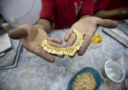A worker holds a gold necklace at a gold workshop in the city of Isfahan, 414 km (259 miles) south of Tehran May 3, 2007. REUTERS/Morteza Ni A worker holds a gold necklace at a gold workshop in the city of Isfahan, 414 km (259 miles) south of Tehran May 3, 2007. REUTERS/Morteza Ni