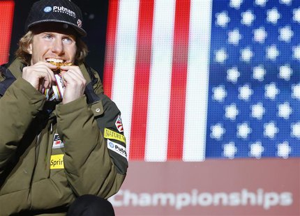 Gold medallist Ted Ligety of the U.S. bites his gold medals during the medal ceremony of the men's giant slalom event at the FIS alpine skii Gold medallist Ted Ligety of the U.S. bites his gold medals during the medal ceremony of the men's giant slalom event at the FIS alpine skii