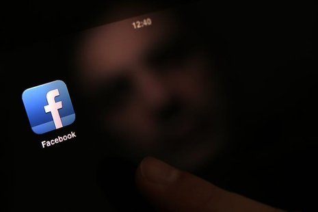 A man uses an iPad with a Facebook app in this photo illustration in Sofia January 30, 2013. REUTERS/Stoyan Nenov A man uses an iPad with a Facebook app in this photo illustration in Sofia January 30, 2013. REUTERS/Stoyan Nenov