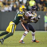 Green Bay Packers cornerback Charles Woodson (L) intercepts the ball against Chicago Bears wide receiver Earl Bennett (80) in the second hal