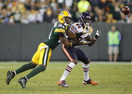 Green Bay Packers cornerback Charles Woodson (L) intercepts the ball against Chicago Bears wide receiver Earl Bennett (80) in the second hal Green Bay Packers cornerback Charles Woodson (L) intercepts the ball against Chicago Bears wide receiver Earl Bennett (80) in the second hal