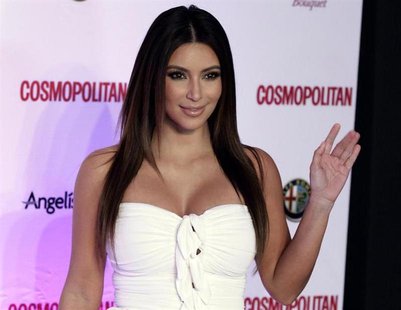 Socialite and reality TV star Kim Kardashian waves to the media as she arrives to attend an event celebrating the 40th anniversary of Cosmop Socialite and reality TV star Kim Kardashian waves to the media as she arrives to attend an event celebrating the 40th anniversary of Cosmop