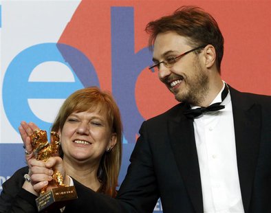 Director Calin Peter Netzer and producer Ada Solomon look at the Golden Bear award received for the Best Film for "Pozitia Copilului" (Child Director Calin Peter Netzer and producer Ada Solomon look at the Golden Bear award received for the Best Film for "Pozitia Copilului" (Child