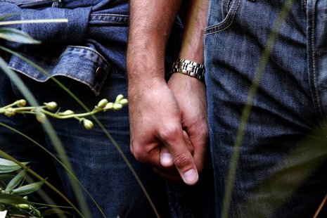 A gay couple hold hands during their symbolic wedding ceremony in central Rome May 21, 2005. REUTERS/Max Rossi A gay couple hold hands during their symbolic wedding ceremony in central Rome May 21, 2005. REUTERS/Max Rossi