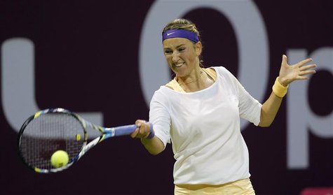 Victoria Azarenka of Belarus returns the ball to Agnieszka Radwanska of Poland during their women's semi-final match at the Qatar Open tenni Victoria Azarenka of Belarus returns the ball to Agnieszka Radwanska of Poland during their women's semi-final match at the Qatar Open tenni