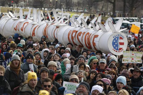 Demonstrators carry a replica of a pipeline during a march against the Keystone XL pipeline in Washington, February 17, 2013. REUTERS/Richar Demonstrators carry a replica of a pipeline during a march against the Keystone XL pipeline in Washington, February 17, 2013. REUTERS/Richar