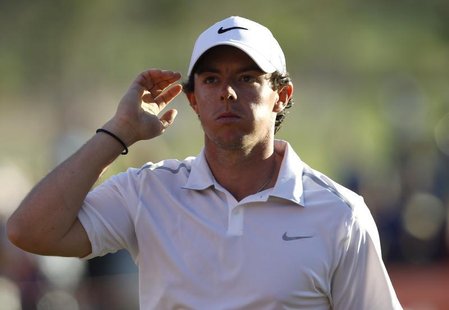 Rory McIlroy of Northern Ireland leaves the 18th green at the end of his match during the second round of the Abu Dhabi Golf Championship at Rory McIlroy of Northern Ireland leaves the 18th green at the end of his match during the second round of the Abu Dhabi Golf Championship at