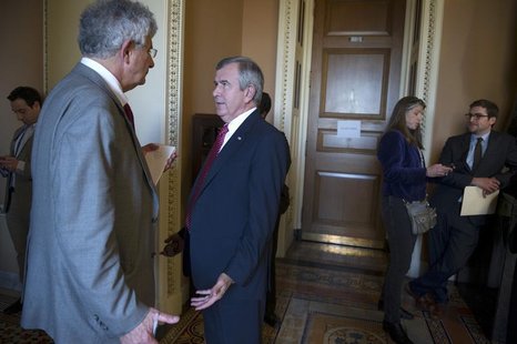 Sen. Mike Johanns (D-NE) (2nd L) speaks to reporters after leaving the Mansfield Room following a caucus meeting at the U.S. Capitol in Wash Sen. Mike Johanns (D-NE) (2nd L) speaks to reporters after leaving the Mansfield Room following a caucus meeting at the U.S. Capitol in Wash