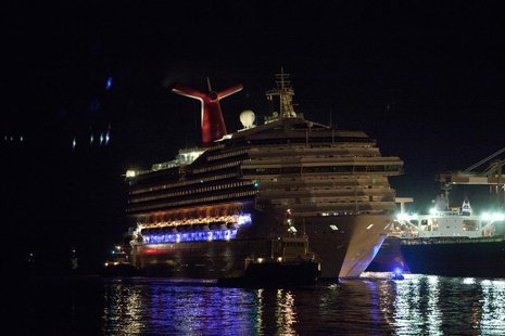 The Carnival Triumph cruise ship is towed towards the dock at the port of Mobile, Alabama, February 14, 2013. REUTERS/ Lyle Ratliff The Carnival Triumph cruise ship is towed towards the dock at the port of Mobile, Alabama, February 14, 2013. REUTERS/ Lyle Ratliff