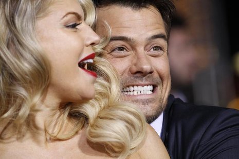 Cast member Josh Duhamel and his wife, Fergie, pose during the premiere of "New Year's Eve" at the Grauman's Chinese theatre in Hollywood, C Cast member Josh Duhamel and his wife, Fergie, pose during the premiere of "New Year's Eve" at the Grauman's Chinese theatre in Hollywood, C