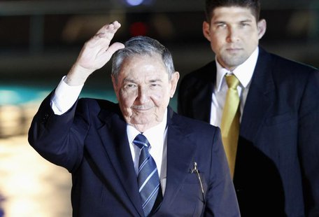 Cuba's President Raul Castro waves to the media before an official dinner at La Moneda Presidential Palace during the summit of the Communit Cuba's President Raul Castro waves to the media before an official dinner at La Moneda Presidential Palace during the summit of the Communit