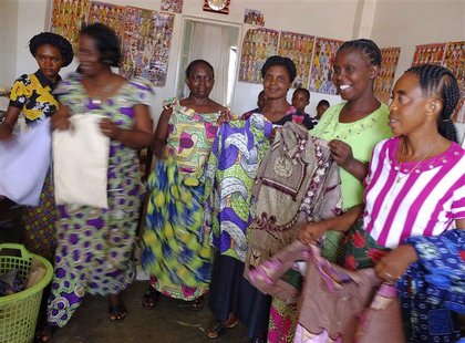 Members of a sewing circle run by woman entrepreneurs pose with garments in the town of Fungurume, close to Tenke Fungurume, a copper and co Members of a sewing circle run by woman entrepreneurs pose with garments in the town of Fungurume, close to Tenke Fungurume, a copper and co