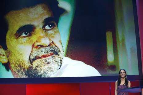 Jury member Shirin Neshat stands next to the picture of director Jafar Panahi before presenting his co-director Kamboziya Partovi with a Sil Jury member Shirin Neshat stands next to the picture of director Jafar Panahi before presenting his co-director Kamboziya Partovi with a Sil