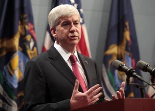 Michigan Governor Rick Snyder holds a news conference to talk about why he signed into law, earlier in the day, right-to-work laws in Lansin