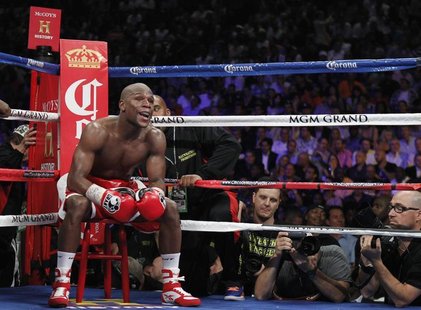 Floyd Mayweather Jr. of the U.S. sits on a stool as he waits for a round to start during his title fight against WBA super welterweight cham Floyd Mayweather Jr. of the U.S. sits on a stool as he waits for a round to start during his title fight against WBA super welterweight cham