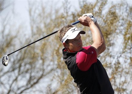 Luke Donald of England watches his tee shot on the ninth hole during a practice round for the WGC-Accenture Match Play Championship golf tou Luke Donald of England watches his tee shot on the ninth hole during a practice round for the WGC-Accenture Match Play Championship golf tou