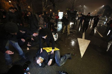 Protesters lie on the ground after clashes with riot police during a protest against high electricity prices in Sofia February 19, 2013. REU Protesters lie on the ground after clashes with riot police during a protest against high electricity prices in Sofia February 19, 2013. REU