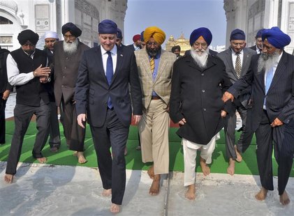 Britain's Prime Minister David Cameron (4th R) walks inside the premises of the holy Sikh shrine of Golden temple in the northern Indian cit Britain's Prime Minister David Cameron (4th R) walks inside the premises of the holy Sikh shrine of Golden temple in the northern Indian cit