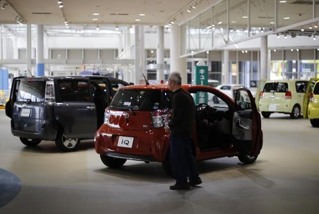 A visitor looks at Toyota Motor Corp cars at the company's showroom in Tokyo February 5, 2013. REUTERS/Toru Hanai A visitor looks at Toyota Motor Corp cars at the company's showroom in Tokyo February 5, 2013. REUTERS/Toru Hanai