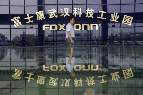 A man walks past a logo of a Foxconn factory in Wuhan, Hubei province, August 31, 2012. REUTERS/Stringer A man walks past a logo of a Foxconn factory in Wuhan, Hubei province, August 31, 2012. REUTERS/Stringer