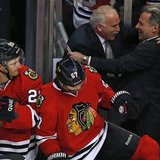 Chicago Blackhawks' head coach Joel Quenneville (back 2nd R) is congratulated after his team's win over the Vancouver Canucks in their NHL hockey game in Chicago, Illinois, February 19, 2013. 
REUTERS/Jim Young