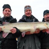 Joseph Seeberger (center) and friends holds up the record breaking muskie.