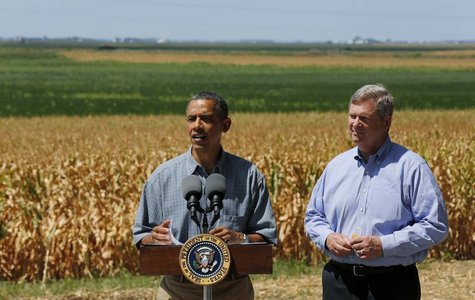U.S. President Barack Obama talks next to U.S. Secretary of Agriculture Tom Vilsack after they tour the McIntosh family farm with the owners U.S. President Barack Obama talks next to U.S. Secretary of Agriculture Tom Vilsack after they tour the McIntosh family farm with the owners