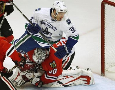 Vancouver Canucks' Jannik Hansen (top) crashes into Chicago Blackhawks' goalie Ray Emery during the third period of their NHL hockey game in Vancouver Canucks' Jannik Hansen (top) crashes into Chicago Blackhawks' goalie Ray Emery during the third period of their NHL hockey game in
