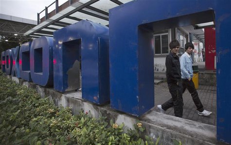 Workers walk out at the gate of a Foxconn factory in the township of Longhua in Shenzhen, Guangdong province December 18, 2012. REUTERS/Tyro Workers walk out at the gate of a Foxconn factory in the township of Longhua in Shenzhen, Guangdong province December 18, 2012. REUTERS/Tyro