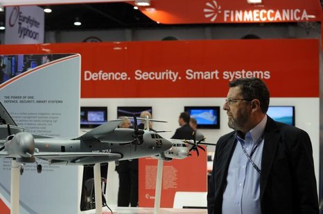 A visitor walks past a stand for Italian defence group Finmeccanica during the International Defence Exhibition and Conference (IDEX) at the A visitor walks past a stand for Italian defence group Finmeccanica during the International Defence Exhibition and Conference (IDEX) at the