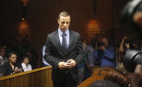 Oscar Pistorius enters the dock during a break in court proceedings at the Pretoria Magistrates court, February 21, 2013. REUTERS/Mike Hutch Oscar Pistorius enters the dock during a break in court proceedings at the Pretoria Magistrates court, February 21, 2013. REUTERS/Mike Hutch