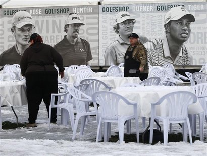 Concession workers clear snow from tables as weather on the golf course continues to delay first round play of the WGC-Accenture Match Play Concession workers clear snow from tables as weather on the golf course continues to delay first round play of the WGC-Accenture Match Play