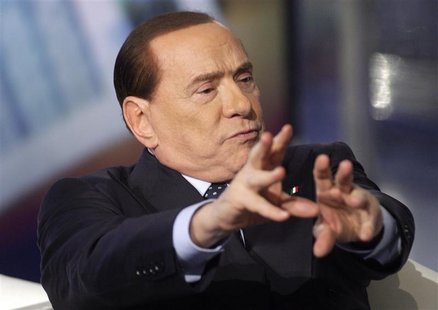 Italy's former Prime Minister Silvio Berlusconi gestures as he appears as a guest on the RAI television show Porta a Porta (Door to Door) in Italy's former Prime Minister Silvio Berlusconi gestures as he appears as a guest on the RAI television show Porta a Porta (Door to Door) in