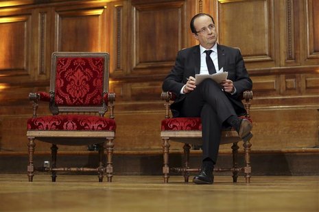French President Francois Hollande holds his notes as he attends a conference on "Civil servants in Dictatorial Europe" at the Sorbonne in P French President Francois Hollande holds his notes as he attends a conference on "Civil servants in Dictatorial Europe" at the Sorbonne in P