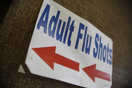 A sign advertising adult flu shots adorns the wall inside the Dallas County Department of Health and Human Services building in Dallas, Texa A sign advertising adult flu shots adorns the wall inside the Dallas County Department of Health and Human Services building in Dallas, Texa