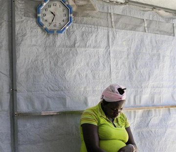 A woman suspected of having cholera waits to be evaluated at a cholera treatment centre run by Medecins Sans Frontieres (Doctors Without Bor A woman suspected of having cholera waits to be evaluated at a cholera treatment centre run by Medecins Sans Frontieres (Doctors Without Bor