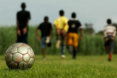 Young boys warm up before soccer training in a Soweto township near Johannesburg, South Africa, October 4, 2005. REUTERS/Siphiwe Sibeko Young boys warm up before soccer training in a Soweto township near Johannesburg, South Africa, October 4, 2005. REUTERS/Siphiwe Sibeko