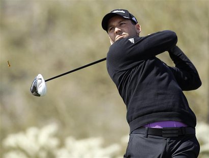 Spanish golfer Sergio Garcia hits off the 17th tee against Thailand's Thongchai Jaidee during the weather delayed first round of the WGC-Acc Spanish golfer Sergio Garcia hits off the 17th tee against Thailand's Thongchai Jaidee during the weather delayed first round of the WGC-Acc