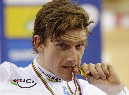 Ireland's Martyn Irvine poses for a photo with his gold medal after the men's scratch race final at the 2013 UCI Track Cycling World Champio Ireland's Martyn Irvine poses for a photo with his gold medal after the men's scratch race final at the 2013 UCI Track Cycling World Champio