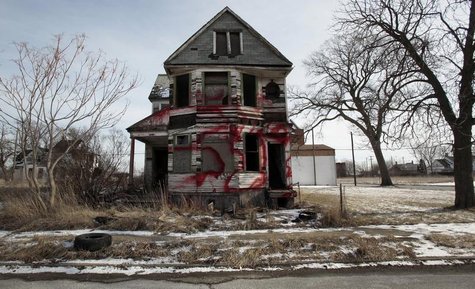 A vacant and blighted home, covered with red spray paint, sits alone in an east side neighborhood once full of homes in Detroit, Michigan Ja A vacant and blighted home, covered with red spray paint, sits alone in an east side neighborhood once full of homes in Detroit, Michigan Ja