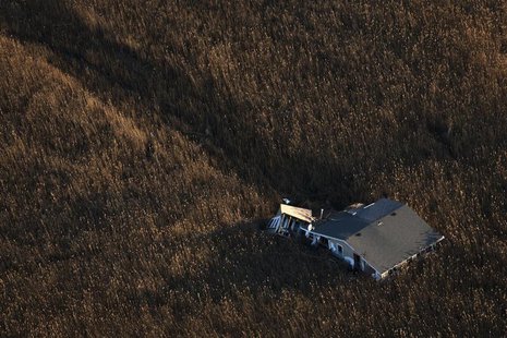 An aerial view shows a house pushed into marshland almost a month after the Oakwood neighborhood in the Staten Island borough of New York wa An aerial view shows a house pushed into marshland almost a month after the Oakwood neighborhood in the Staten Island borough of New York wa