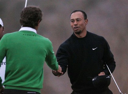 Tiger Woods of the U.S. shakes hands on the 17th green losing 2&1 to Charles Howell III of the U.S. during the weather delayed first round o Tiger Woods of the U.S. shakes hands on the 17th green losing 2&1 to Charles Howell III of the U.S. during the weather delayed first round o