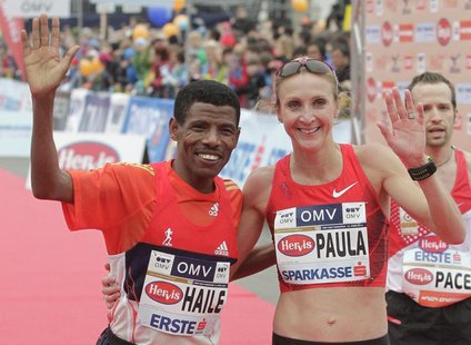 Ethiopian world marathon record holder Haile Gebrselassie and Paula Radcliffe of the UK wave to the crowd after the half marathon race durin Ethiopian world marathon record holder Haile Gebrselassie and Paula Radcliffe of the UK wave to the crowd after the half marathon race durin